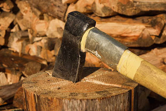 Axe in log on a firewoods background